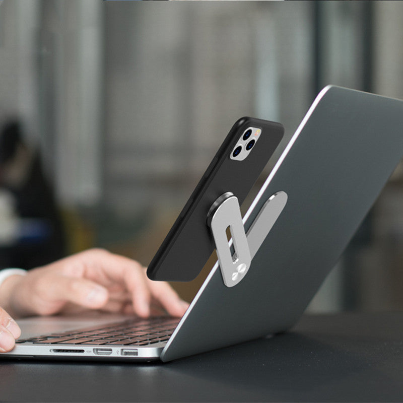 Silver grey adjustable flat expansion bracket used as a computer stand, made of aluminum alloy.