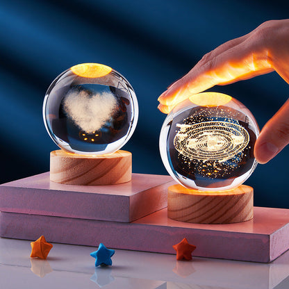 Crystal Ball 3D carved night light with solar system design and warm glow.